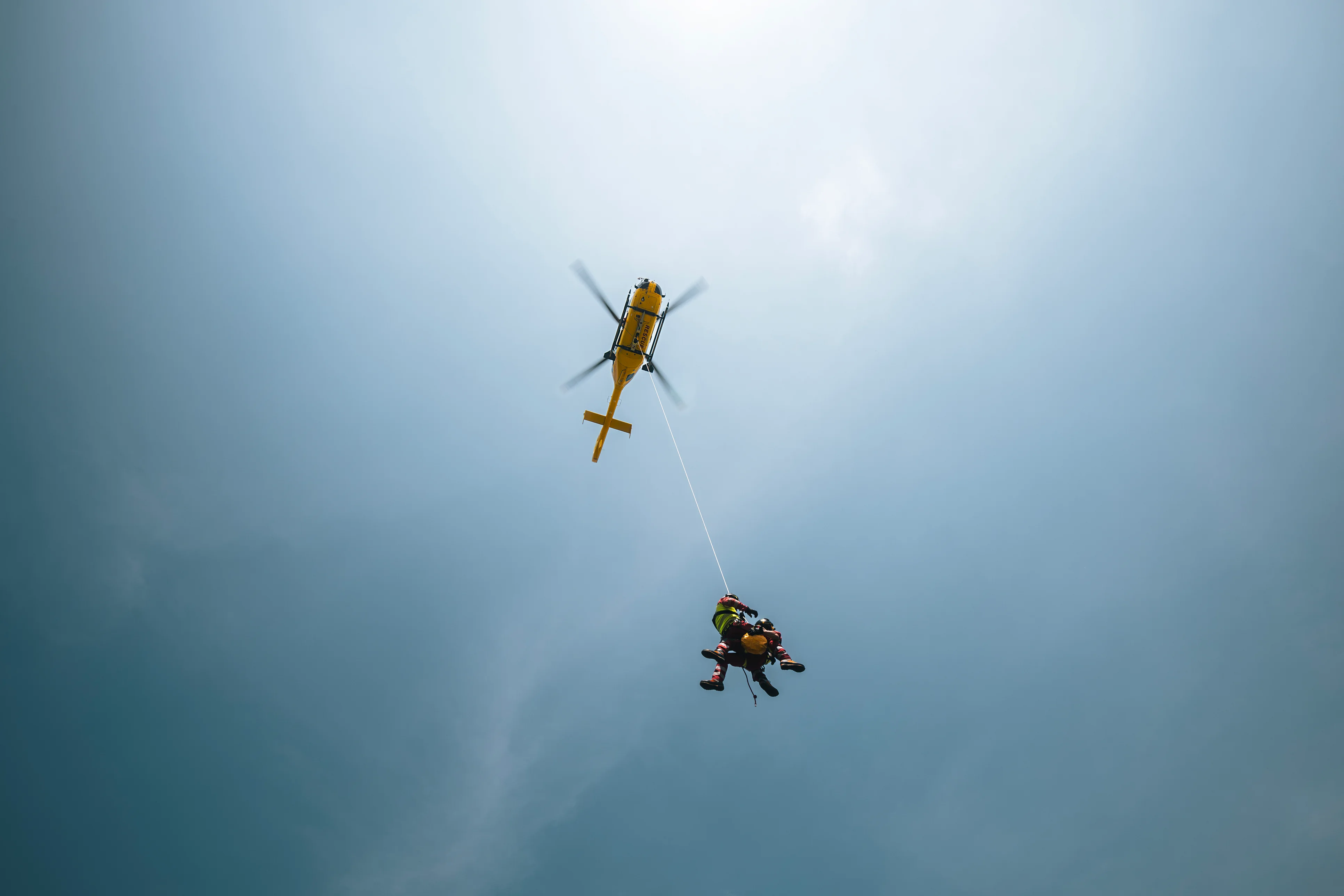 Rescue helicopter hoisting a medical team — healthcare professionals deployed where care is needed